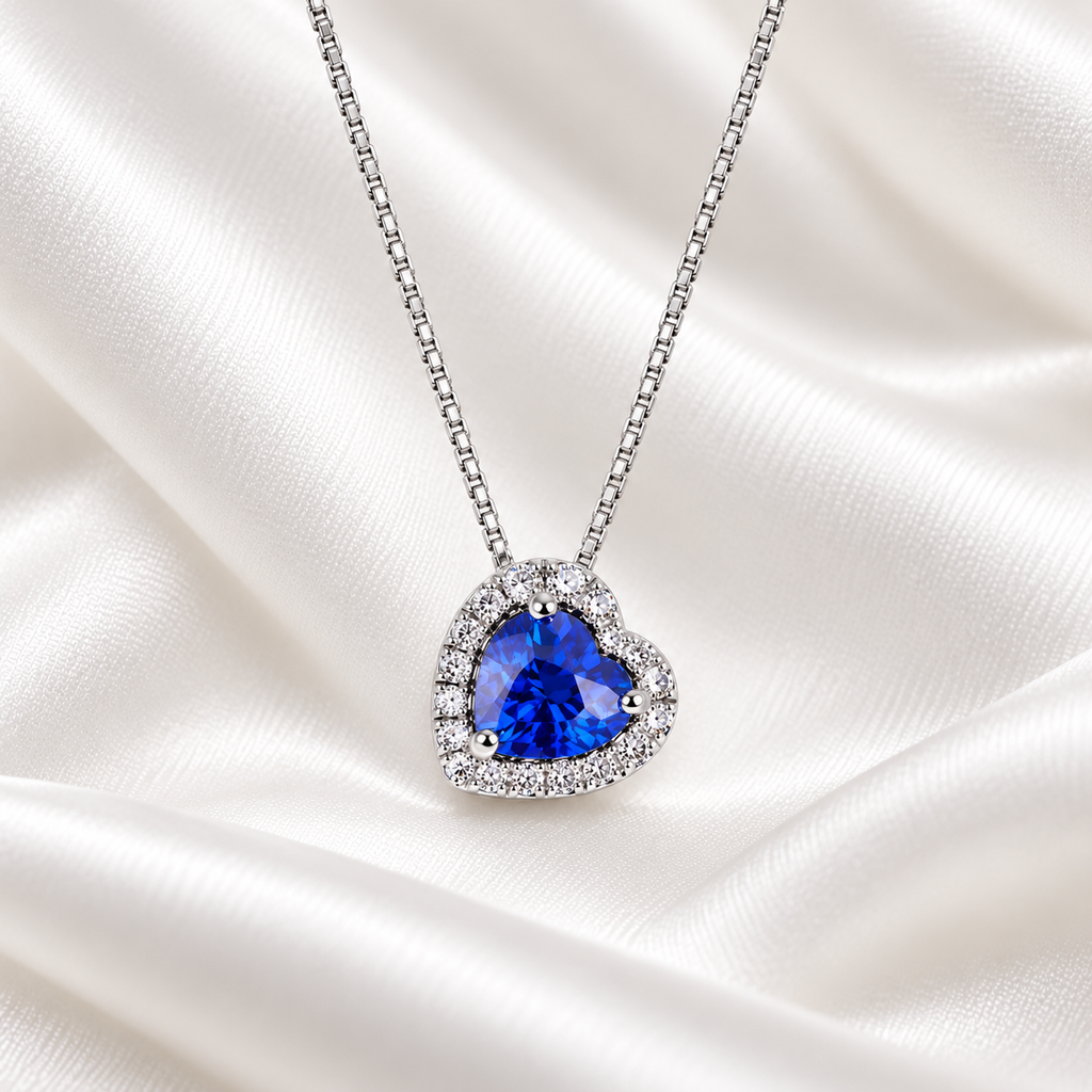 Collana in oro bianco 18k con pendente a cuore con zaffiro blu e diamanti