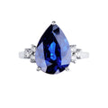Anello Armonia in oro bianco 18k con grande zaffiro blu a goccia e 3 diamanti per lato